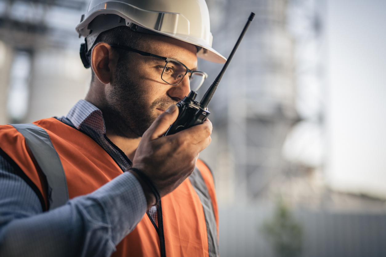 Oil & Gas working using a two-way radio for emergency communications
