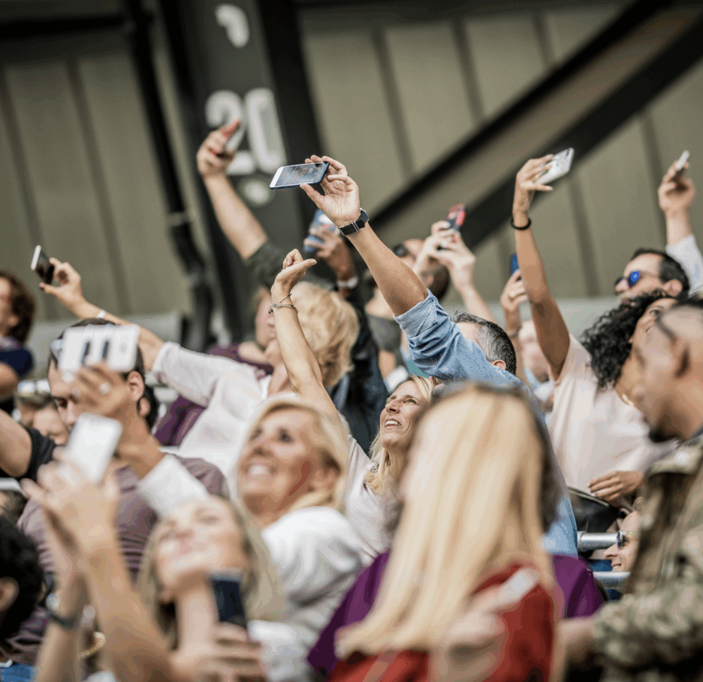 Large crowd using mobile phones at a public venue requiring reliable wireless connectivity